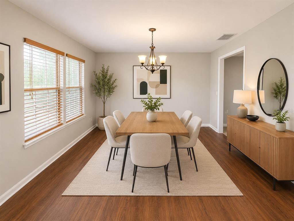 A dining room features a wooden table, six upholstered chairs, a chandelier, and a sideboard — 4104 QUAIL NEST COURT, ST CLOUD, FL
