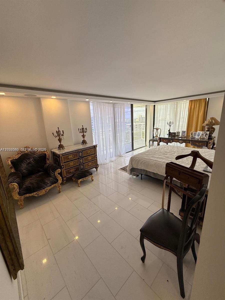 A bedroom features white tile floors, ornate gold furniture, and a balcony with city views — SUNNY ISLES BEACH, FL