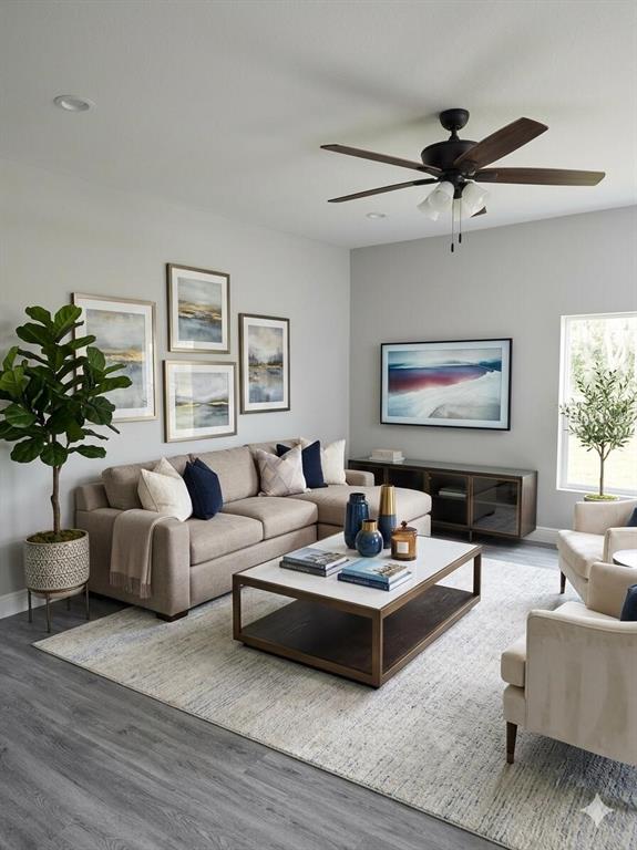 A living room features a beige sectional, a coffee table, and a ceiling fan — 802 MARVIN C ZANDERS AVENUE, APOPKA, FL