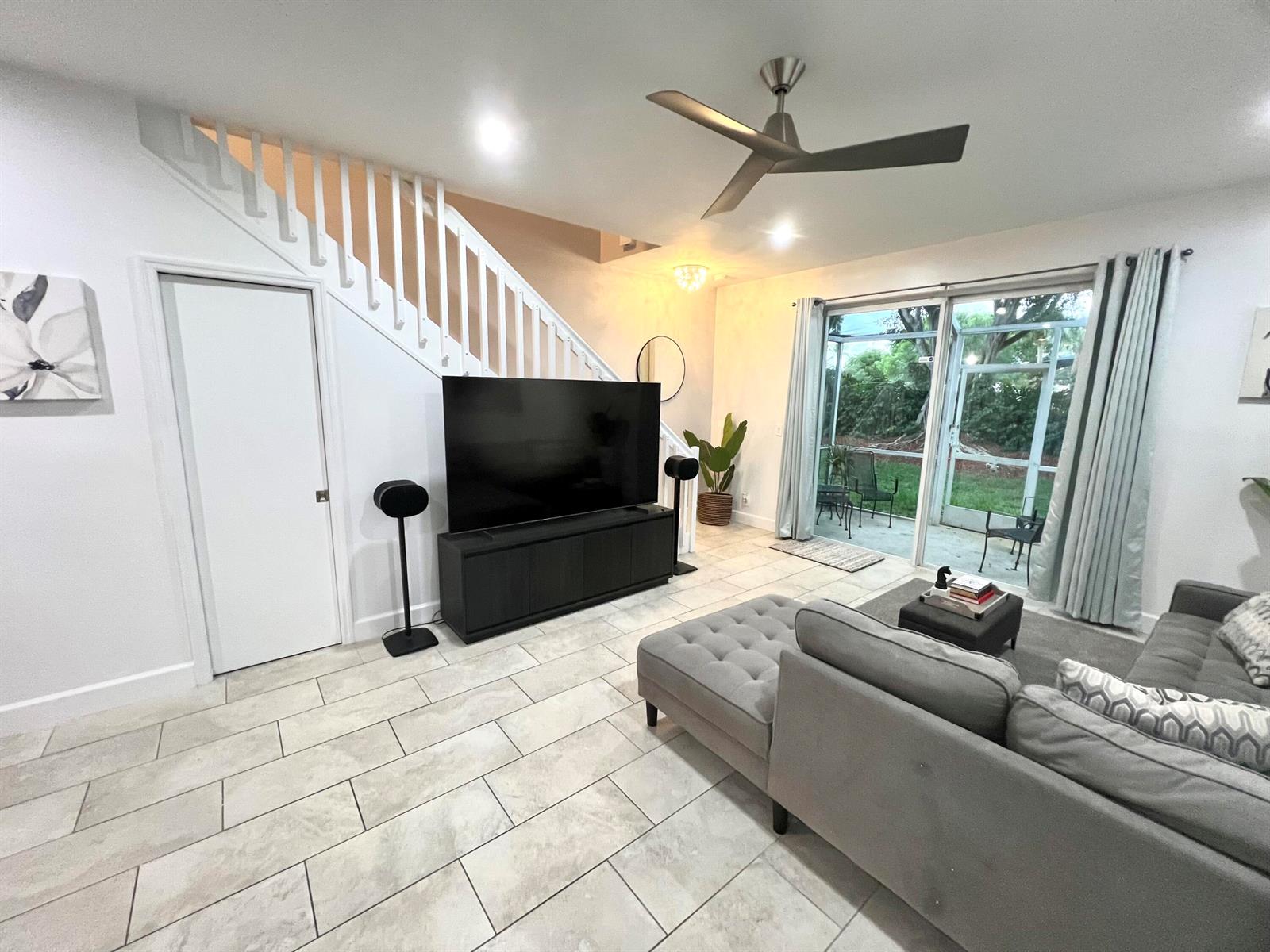 A living room features tile flooring, a staircase, a television console, and a sliding glass door — 2046 Madeira Drive, Weston FL 33327, WESTON, FL