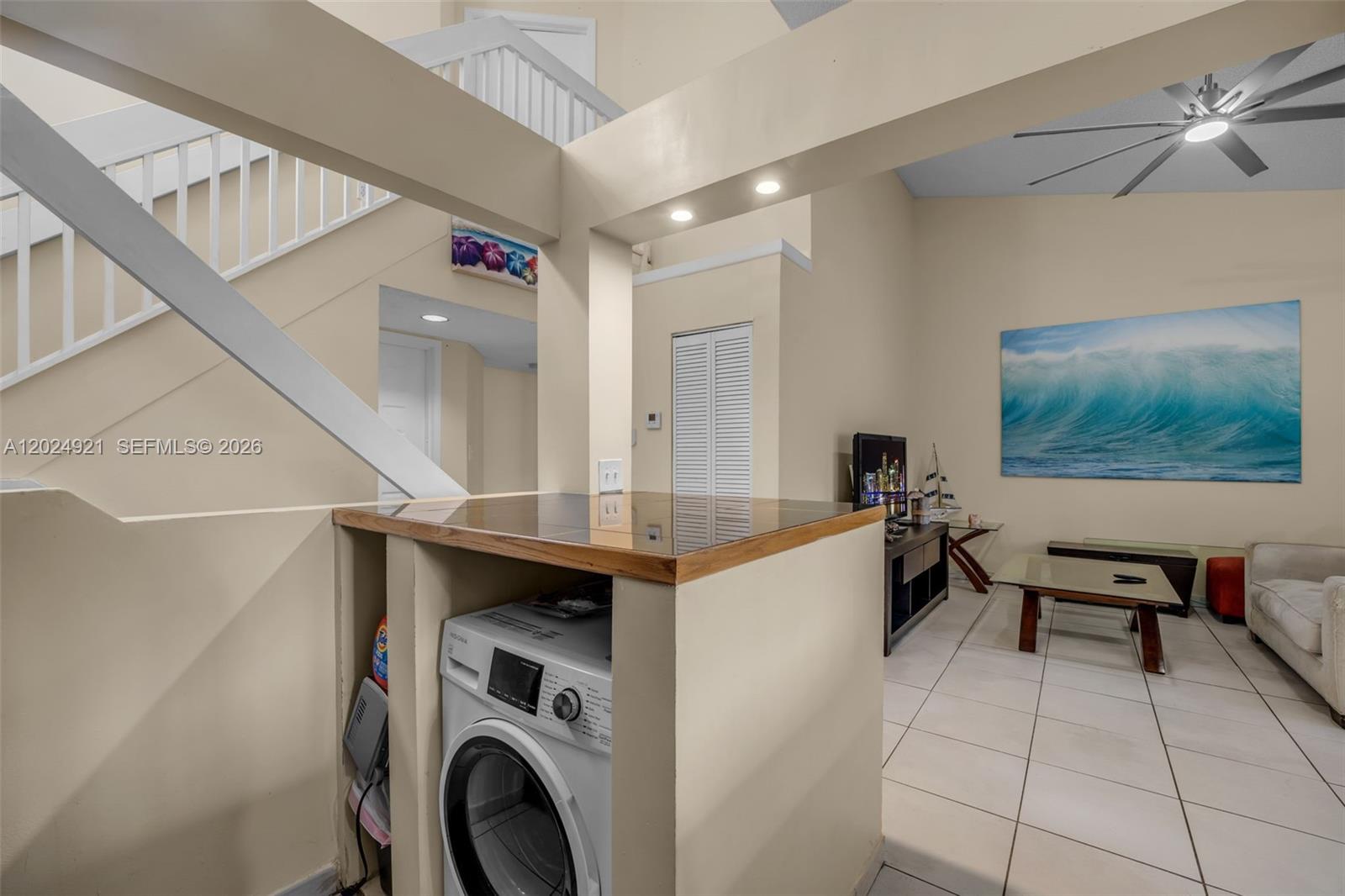 A living area features a built-in laundry nook with a washer under a counter — 14018 SW 91st Ter # 14018, Miami FL 33186, MIAMI, FL
