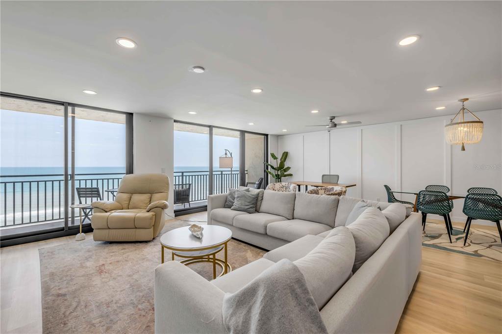 A living and dining area features a large sectional sofa, ocean views, and recessed lighting — 4139 S ATLANTIC AVENUE UNIT B707, NEW SMYRNA BEACH, FL