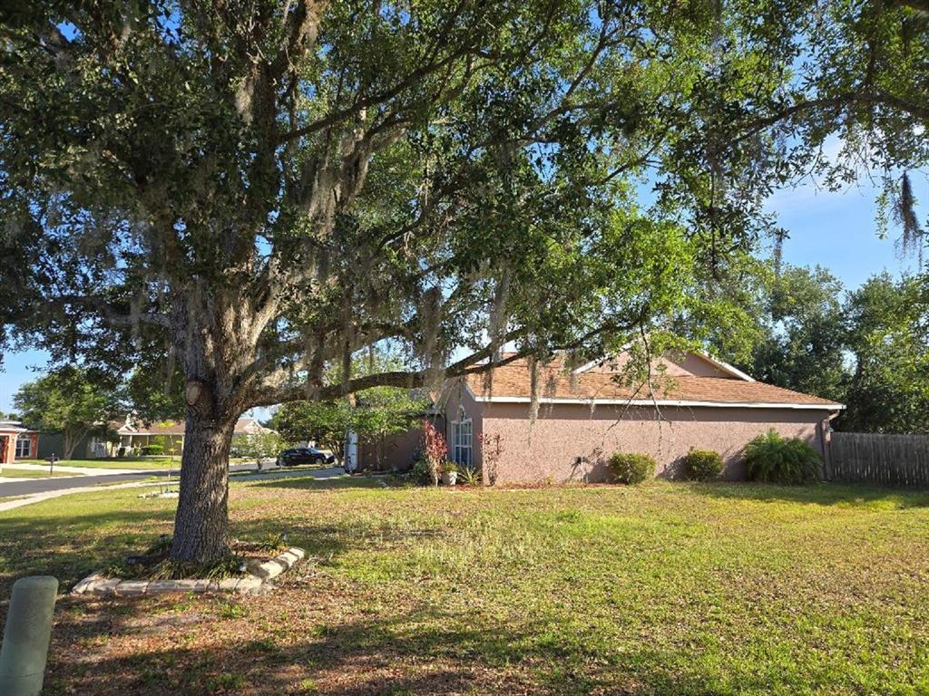 A large oak tree with Spanish moss stands in the front yard of a house — 4199 BANBURY CIRCLE, PARRISH, FL