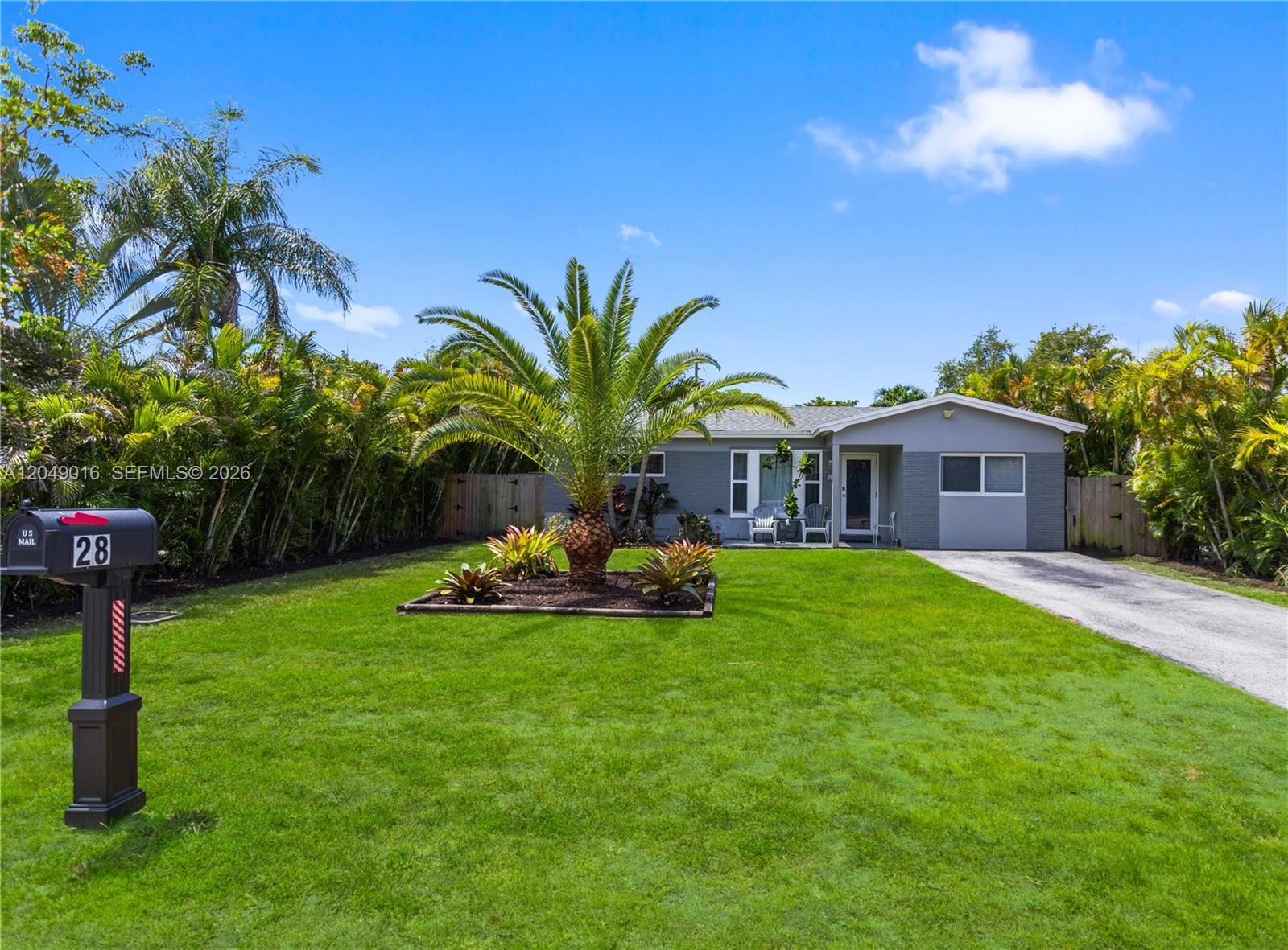A single-story gray house with a front lawn, palm tree, and a mailbox — 28 SE 7th St, Dania Beach FL 33004, DANIA BEACH, FL