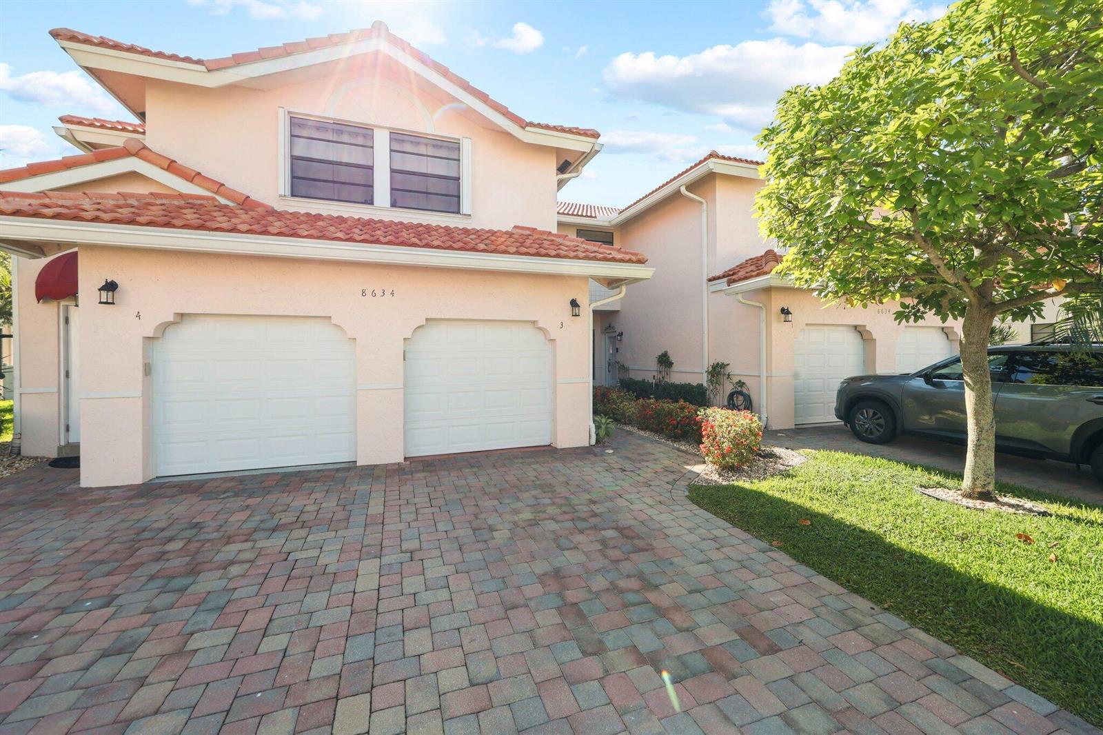 A screened-in patio with tile flooring, a ceiling fan, and views of a lake — 8634 Via Reale # 3, Boca Raton FL 33496, BOCA RATON, FL