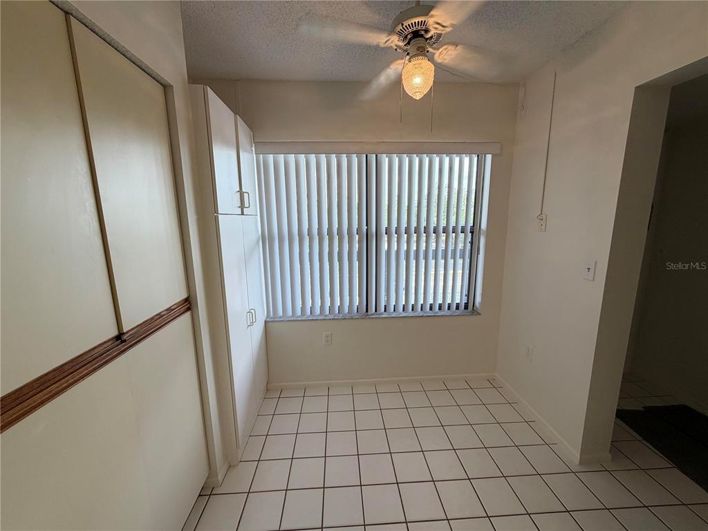 A small room with white tile floors, a ceiling fan, and vertical window blinds — 515 W 30TH AVENUE UNIT 405-H, BRADENTON, FL