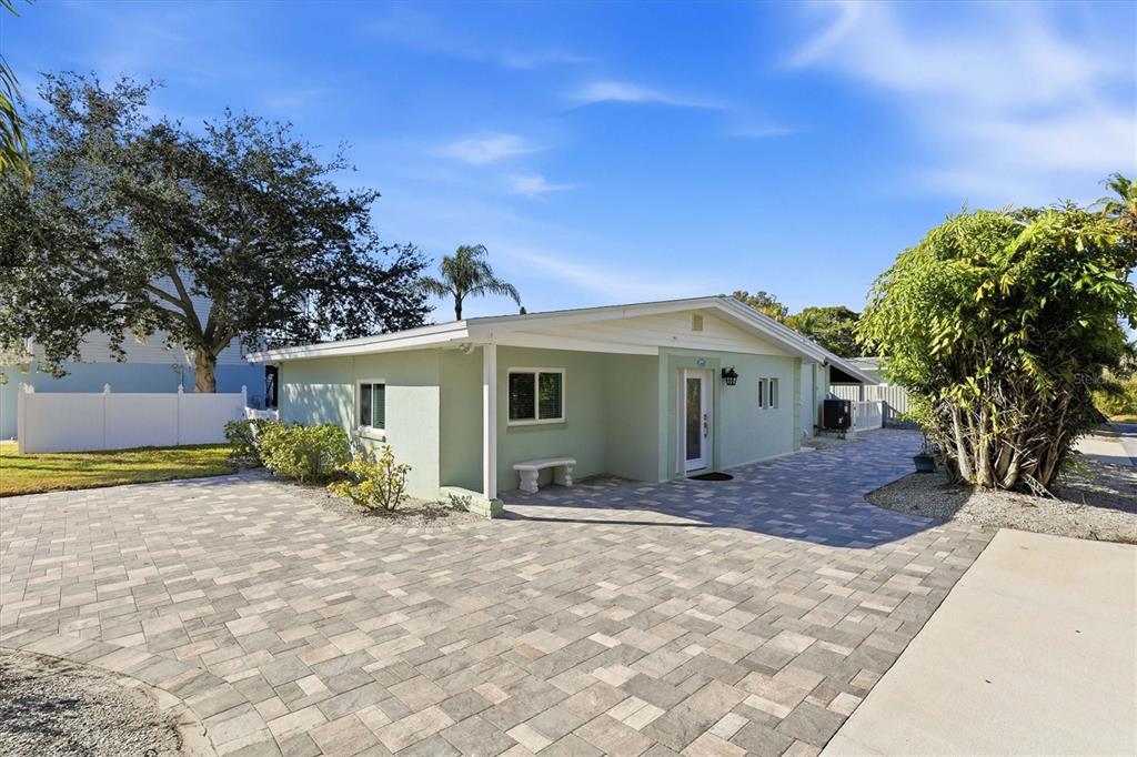 A light green house with a paved driveway and a covered front porch — 302 GEORGIA AVENUE, CRYSTAL BEACH, FL