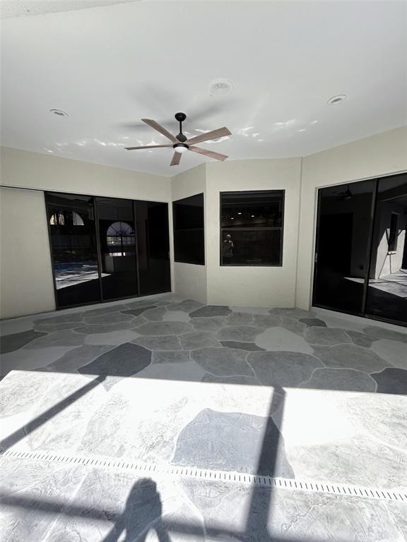 The exterior entrance features a tiled porch, double white doors, and stone-clad support columns — 18608 AUTUMN LAKE BOULEVARD, HUDSON, FL