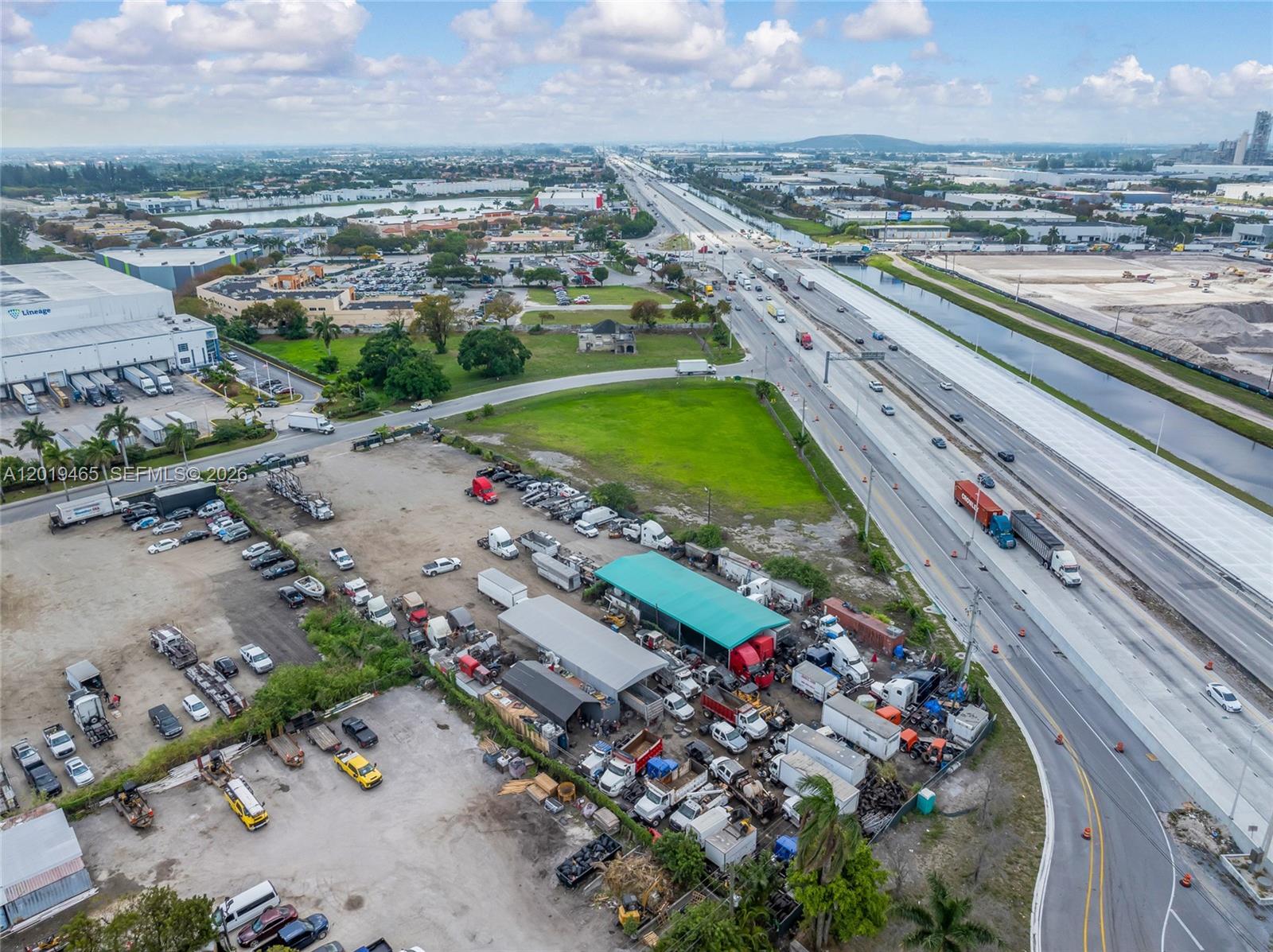An aerial view shows a commercial truck storage yard adjacent to a multi-lane highway — 13800 NW 112th Ave, Hialeah Gardens FL 33018, HIALEAH GARDENS, FL