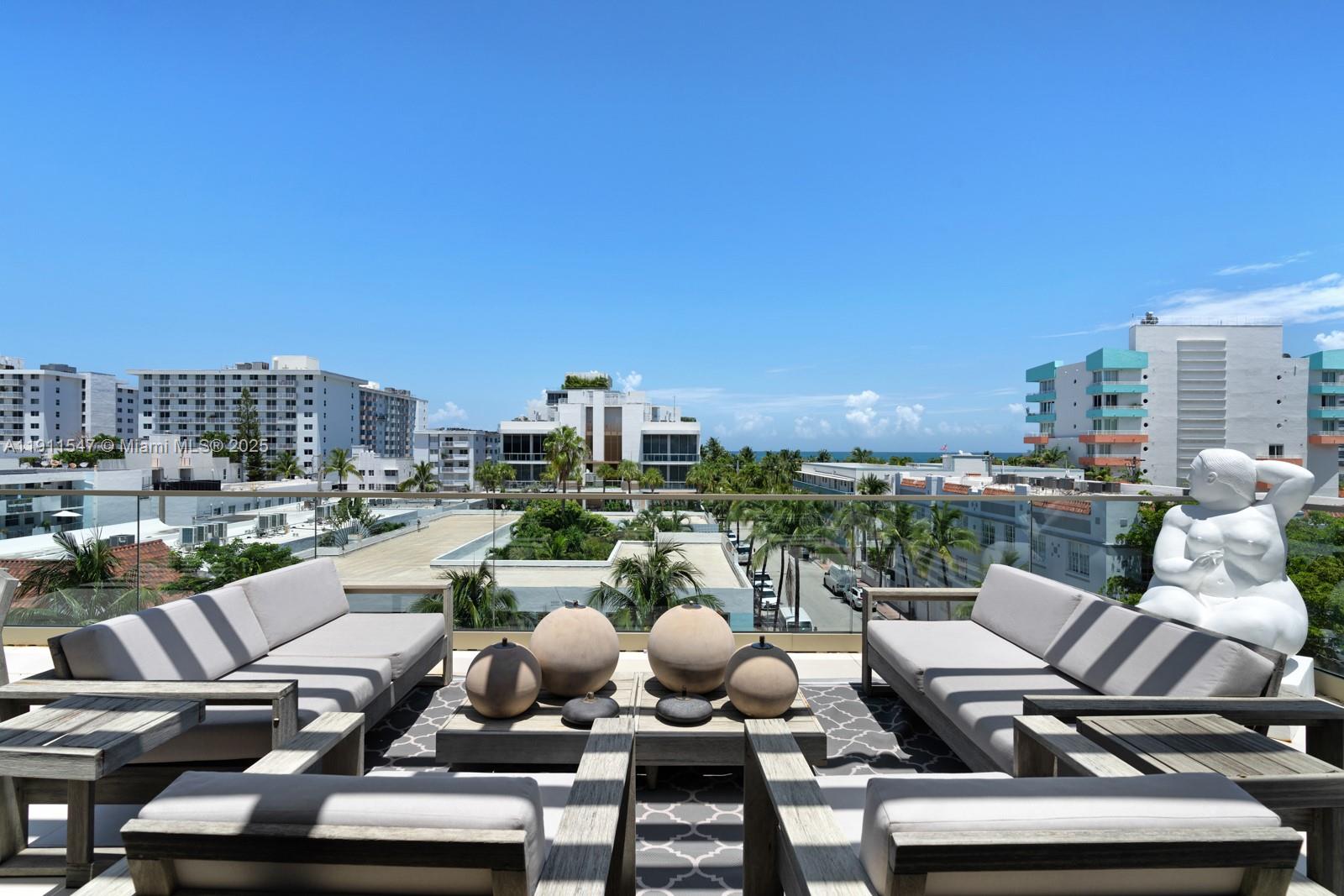 A rooftop terrace features outdoor seating, decorative spheres, and a white sculpture overlooking the city — 300 Collins Ave, Miami Beach FL 33139, MIAMI BEACH, FL