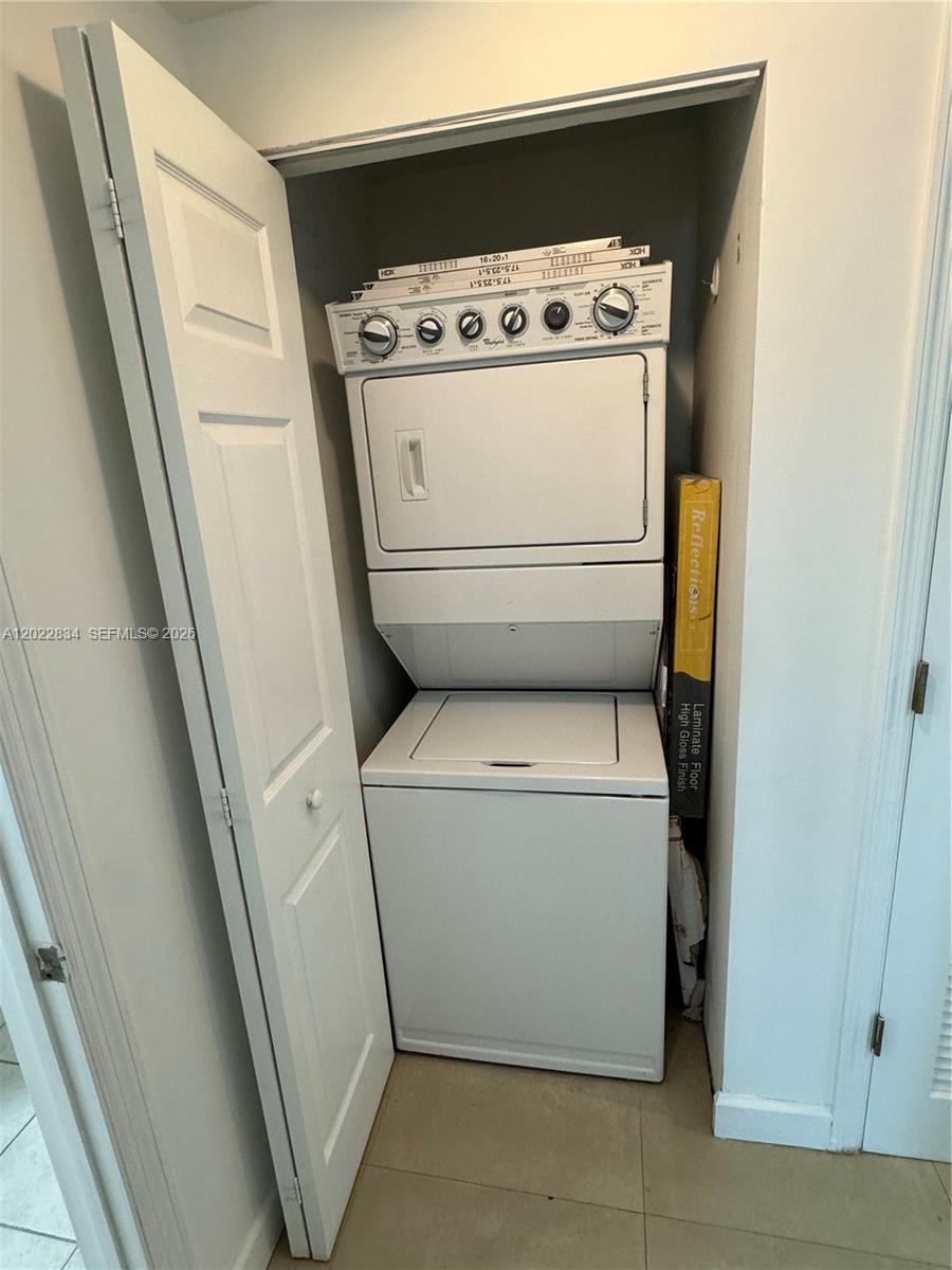 A stacked washer and dryer unit is located inside a small closet — 140 S Dixie Hwy # 521, Hollywood FL 33020, HOLLYWOOD, FL