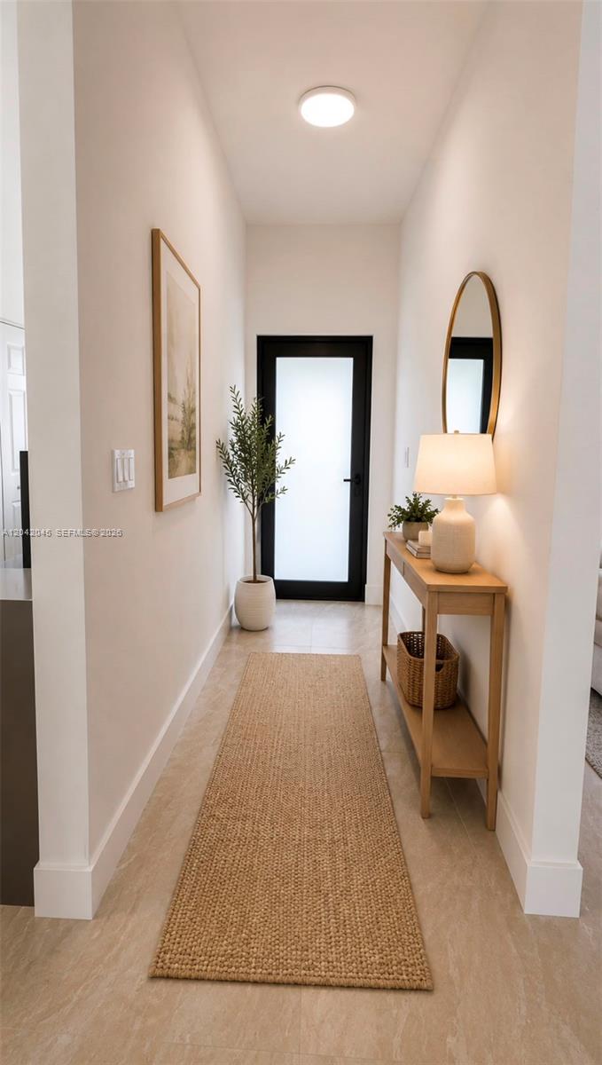 A narrow entryway features a console table, a runner rug, and a glass-paneled front door — 6780 NW 186th Ter, Hialeah FL 33015, HIALEAH, FL