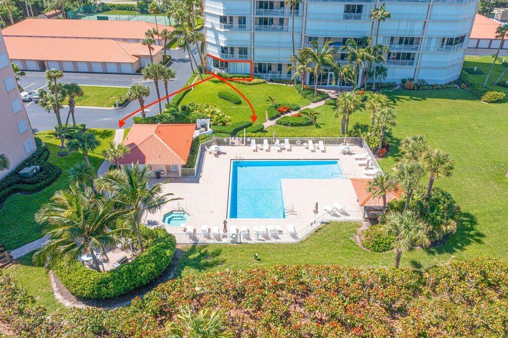 An aerial view shows a condominium building, a swimming pool, and landscaped grounds — 3880 N HIGHWAY A1A UNIT 104, HUTCHINSON ISLAND, FL