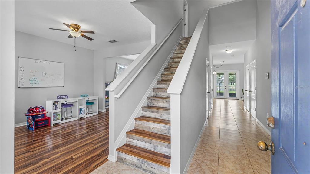 An entryway features a staircase with wood-look treads, tile flooring, and a nearby study area — 2746 WALDEN WOODS DRIVE, PLANT CITY, FL