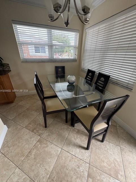 A dining area features a glass-top table, four chairs, tile flooring, and white window blinds — 500 Layne Blvd # 20, Hallandale Beach FL 33009, HALLANDALE BEACH, FL