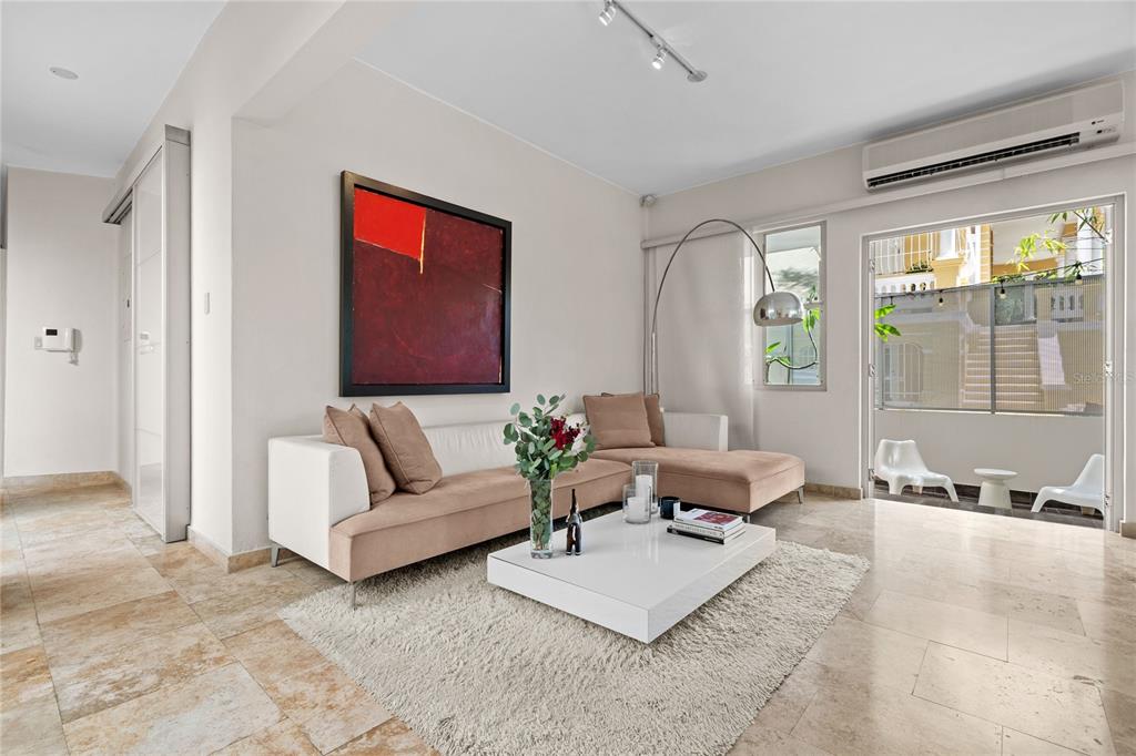 A modern living room features a beige sectional sofa, white coffee table, and tile flooring — 609 MIRAMAR AVENUE UNIT 102, SAN JUAN, PR
