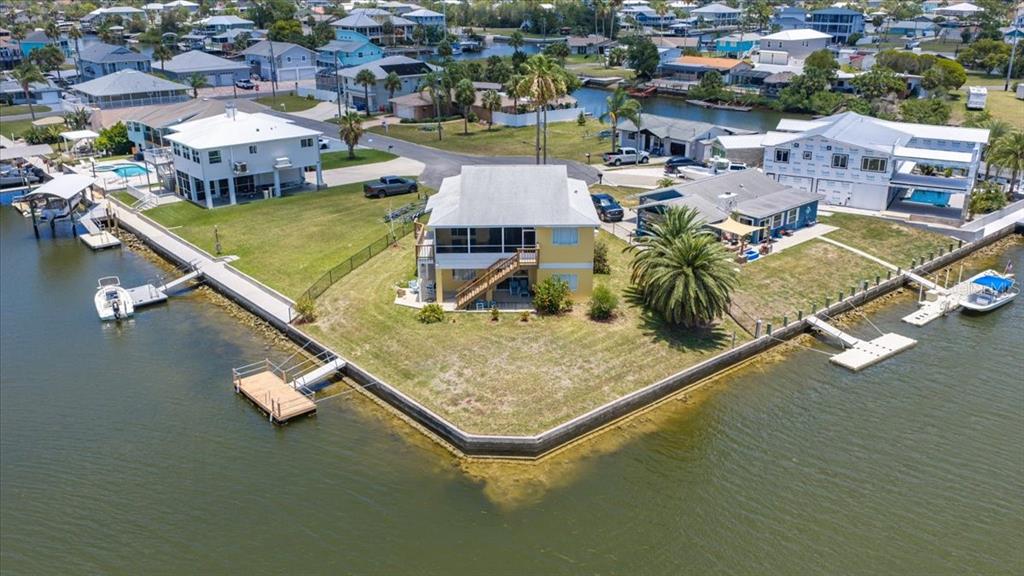 An aerial view shows a waterfront house with a pink outline highlighting the property boundaries — 4365 4TH ISLE DRIVE, HERNANDO BEACH, FL