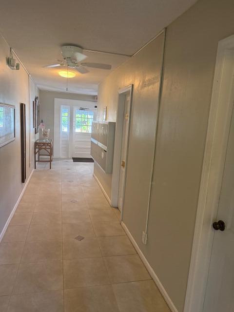 A hallway features light-colored tile flooring, a ceiling fan, and a set of wall-mounted mailboxes — 169 Atlantis Blvd Boulevard # 206, Atlantis FL 33462, ATLANTIS, FL