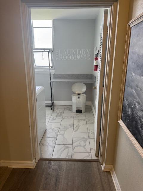 A laundry room with marble-look tile flooring, a countertop, and a white trash can — 169 Atlantis Blvd Boulevard # 206, Atlantis FL 33462, ATLANTIS, FL