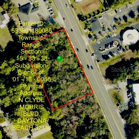 This is an aerial map showing a vacant, wooded lot outlined in red — 650-700 N CLYDE MORRIS BOULEVARD, DAYTONA BEACH, FL