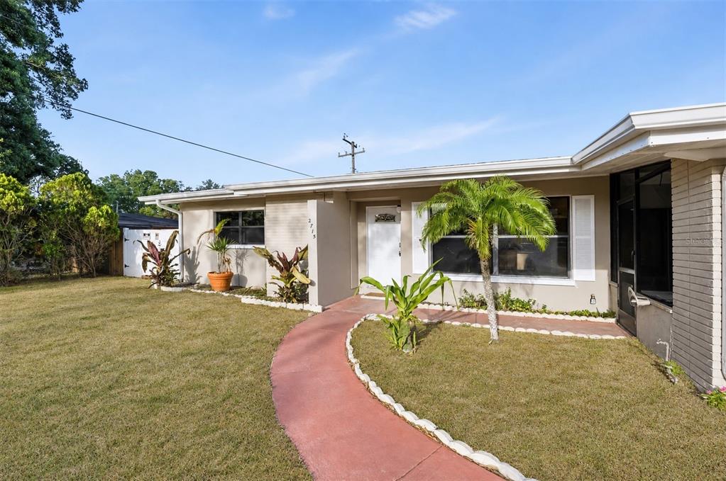 A single-story house with a red walkway, a palm tree, and a white front door — 2715 INGOT PLACE, SARASOTA, FL