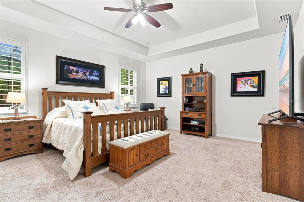 A bedroom features a wooden bed frame, a matching storage bench, and a tall hutch — 517 MORGAN WOOD DRIVE, DELAND, FL