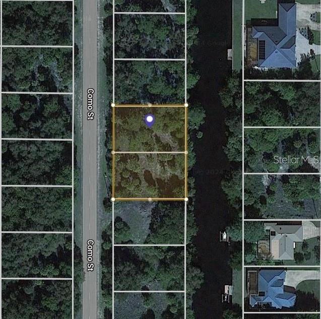 This aerial map shows two adjacent vacant lots situated between a road and a canal — 3100 COMO STREET, PORT CHARLOTTE, FL