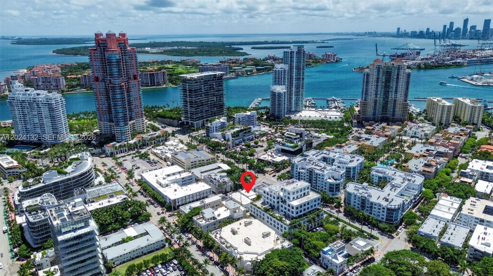An aerial view of a dense urban neighborhood with a red pin marking a building — 233 1st St, Miami Beach FL 33139, MIAMI BEACH, FL