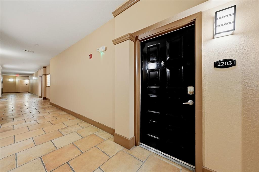 A black apartment door with the number 2203 is located in a tiled hallway — 4221 W SPRUCE STREET UNIT 2203, TAMPA, FL