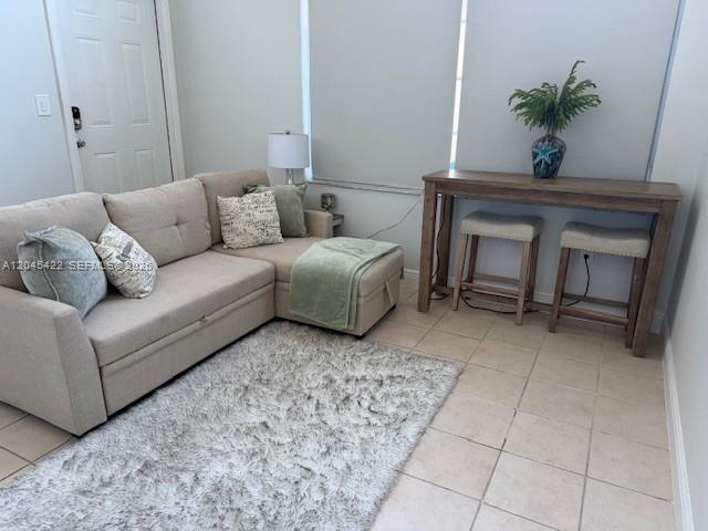 A living room features a beige sectional sofa, a shag rug, and a wooden console table — 8277 NW 194th Ter # 2, Hialeah FL 33015, HIALEAH, FL