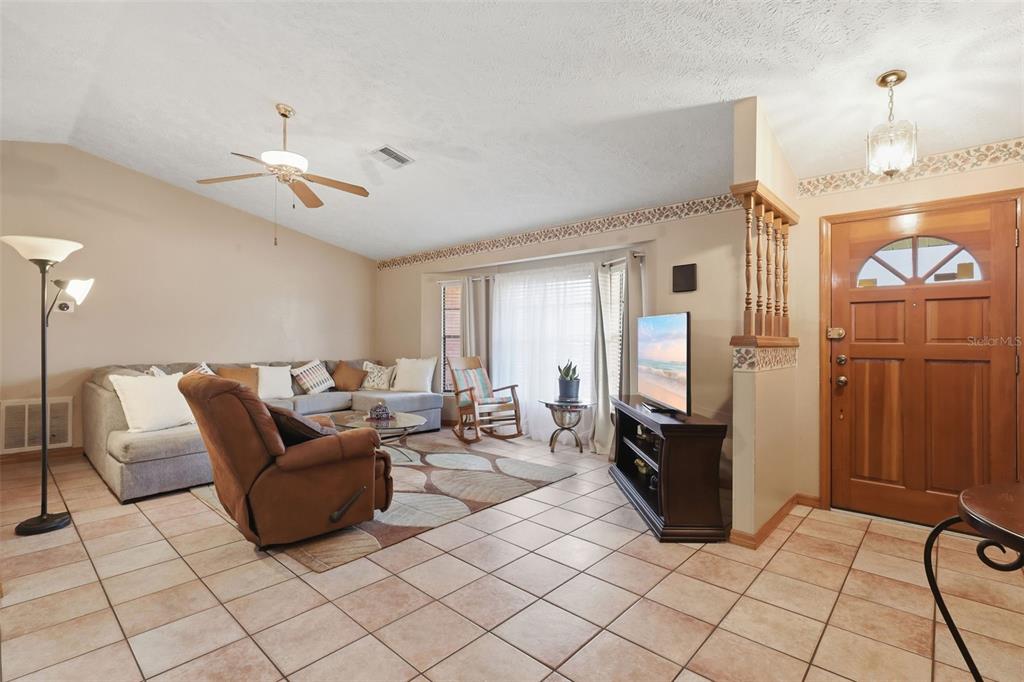 A single-story brick house features a two-car garage, a front lawn, and a concrete driveway — 2287 BELEN DRIVE, DELTONA, FL