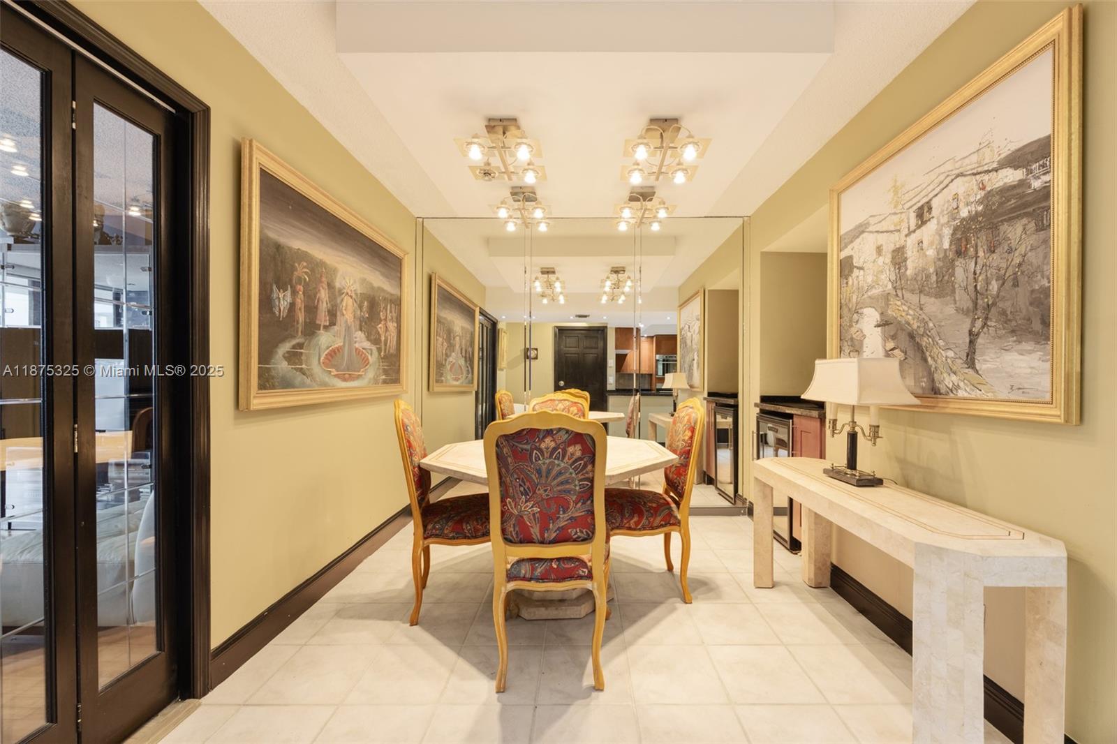 A kitchen features wood cabinets, stainless steel appliances, dark granite countertops, and tiled flooring — 1717 N Bayshore Dr # 3042, Miami FL 33132, MIAMI, FL