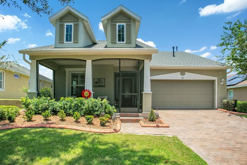 A two-story house with a screened front porch, a two-car garage, and a paved driveway — 397 SILVER MAPLE ROAD, GROVELAND, FL