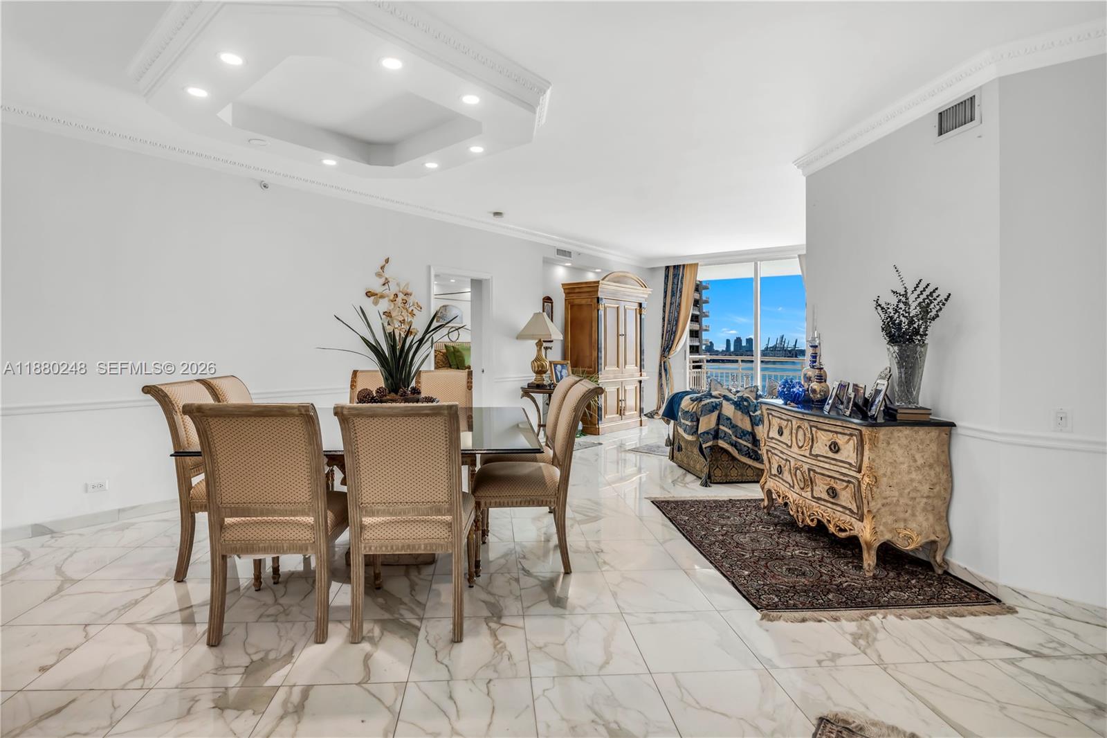 A dining area with marble floors, a glass table, and a view of the city — 888 Brickell Key Dr # 1807, Miami FL 33131, MIAMI, FL