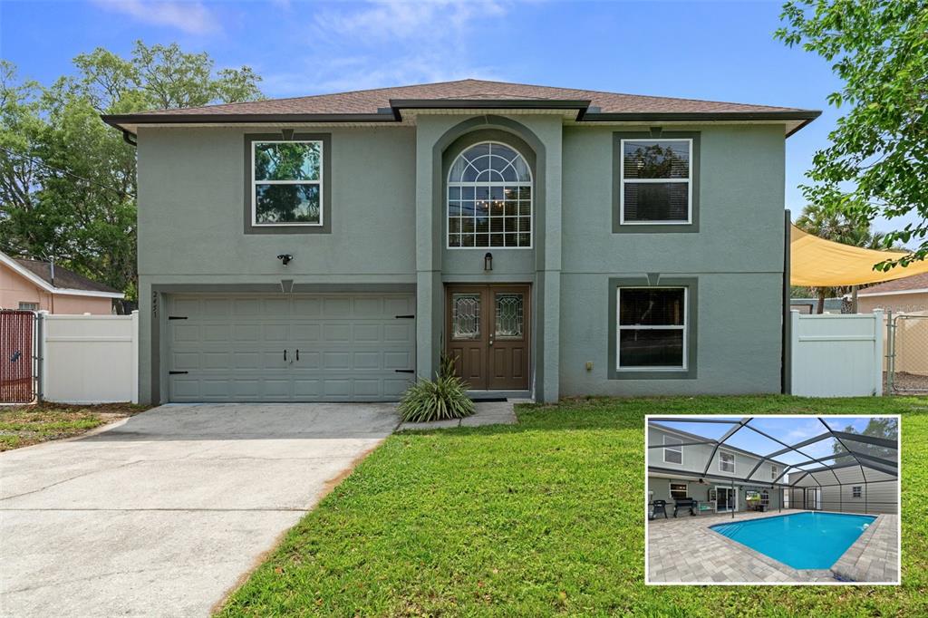 A two-story house with a garage, front entrance, and an inset photo of a pool — 2451 DELTONA BOULEVARD, SPRING HILL, FL