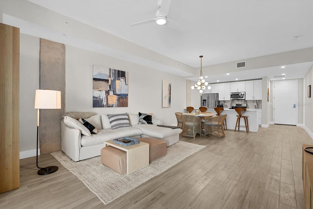 A rectangular swimming pool sits on a paved patio between two modern apartment buildings — 332 COCOANUT AVENUE UNIT 302, SARASOTA, FL