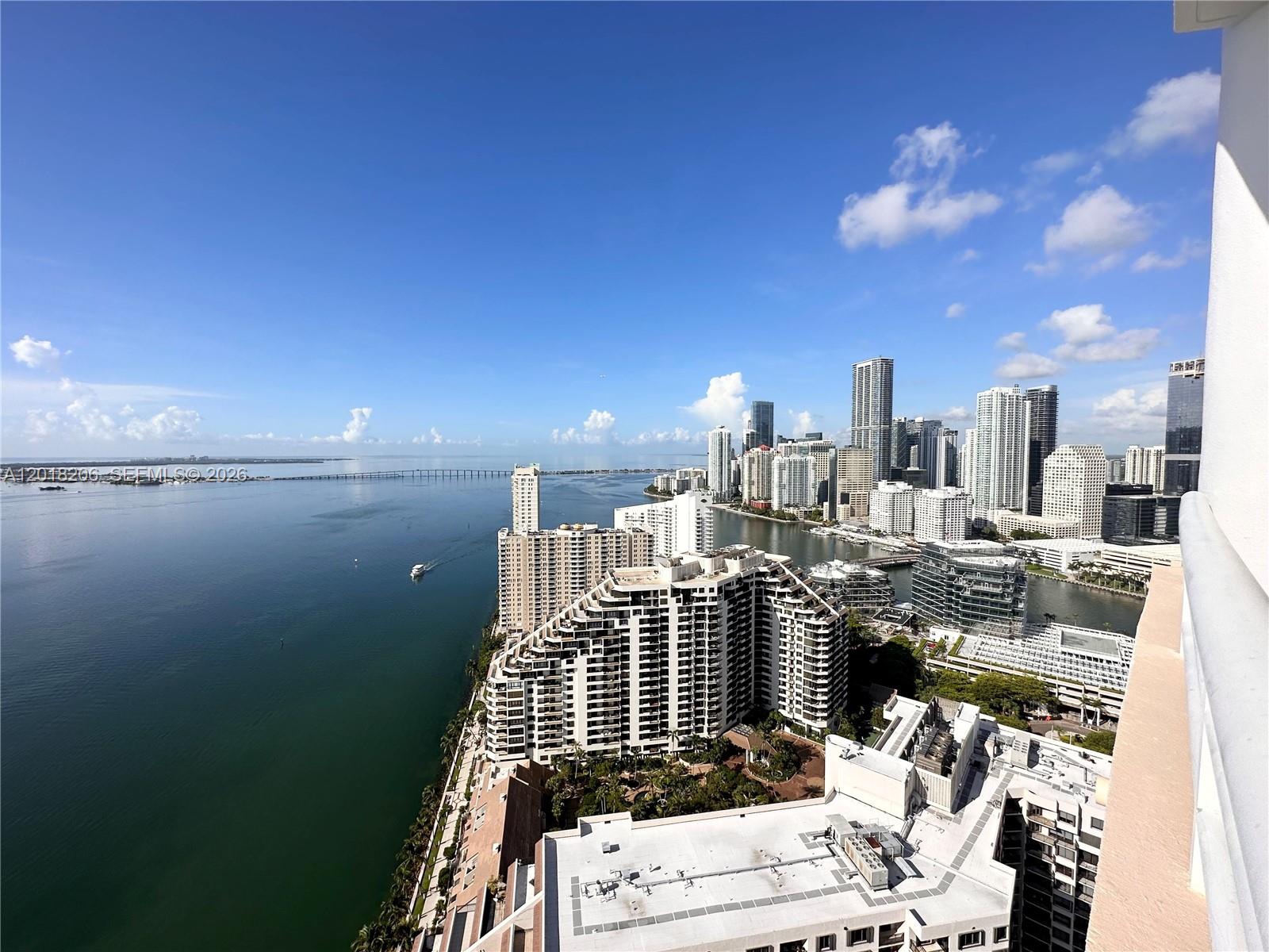 An elevated view of a coastal city skyline overlooking a bay with high-rise buildings — 808 Brickell Key Dr # 3608, Miami FL 33131, MIAMI, FL