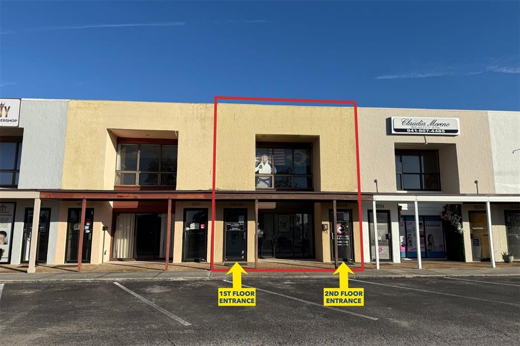 A two-story commercial building exterior with a red outline highlighting a specific unit's entrance — 3627 WEBBER STREET, SARASOTA, FL