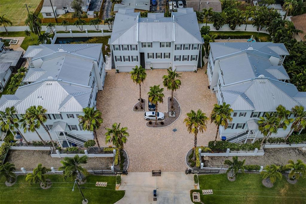 An aerial view of a multi-unit residential complex with a paved courtyard and palm trees — 7010 GREVILLA AVENUE S, SOUTH PASADENA, FL
