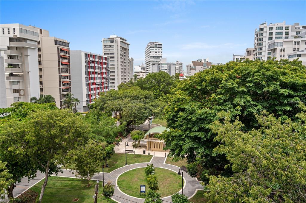 An elevated view of a public park surrounded by high-rise apartment buildings and lush trees — 1223 LUCHETTI STREET UNIT 7S, SAN JUAN, PR