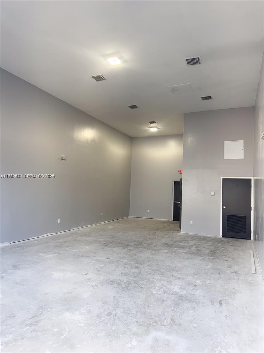 An empty commercial space features gray walls, a concrete floor, and high ceilings — 4030 Pembroke Rd, Hollywood FL 33021, HOLLYWOOD, FL