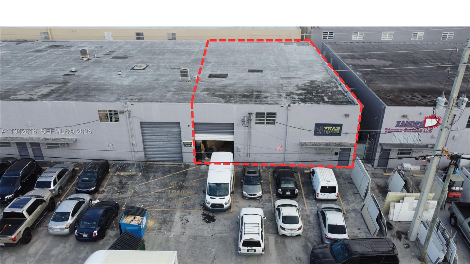 An aerial view shows a commercial warehouse unit with a roll-up door and parking lot — 733 W 26th St # 733, Hialeah FL 33010, HIALEAH, FL