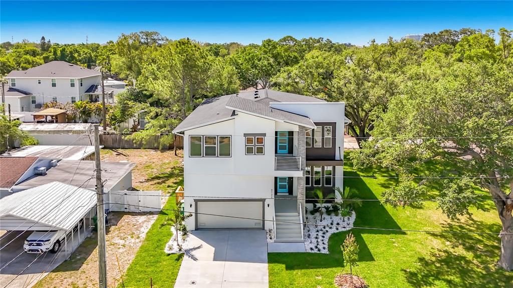 An aerial view of a modern two-story house with a white exterior, garage, and driveway — 4732 W WALLCRAFT AVENUE, TAMPA, FL