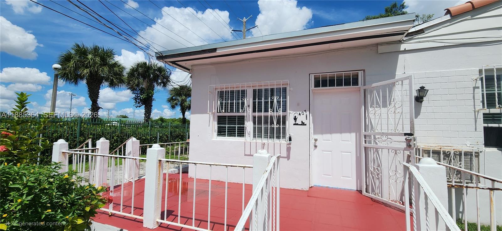 A white house exterior features a red porch, metal security bars, and a white door — 405 NW 64th St, Miami FL 33150, MIAMI, FL