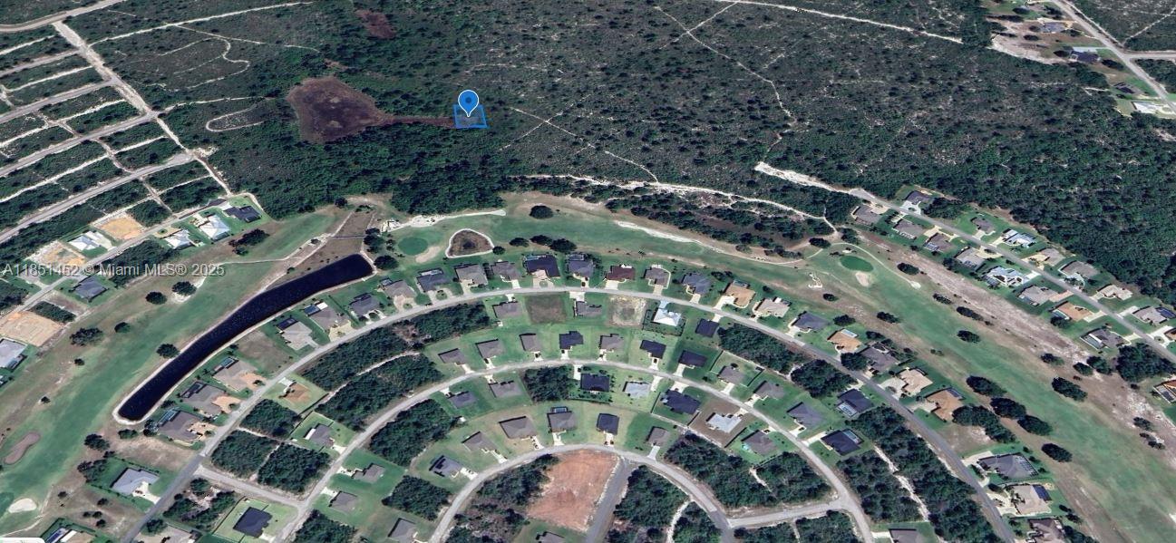An aerial view shows a residential neighborhood bordering a golf course and undeveloped wooded land — 6601 San Bruno Dr, Sebring FL 33872, SEBRING, FL