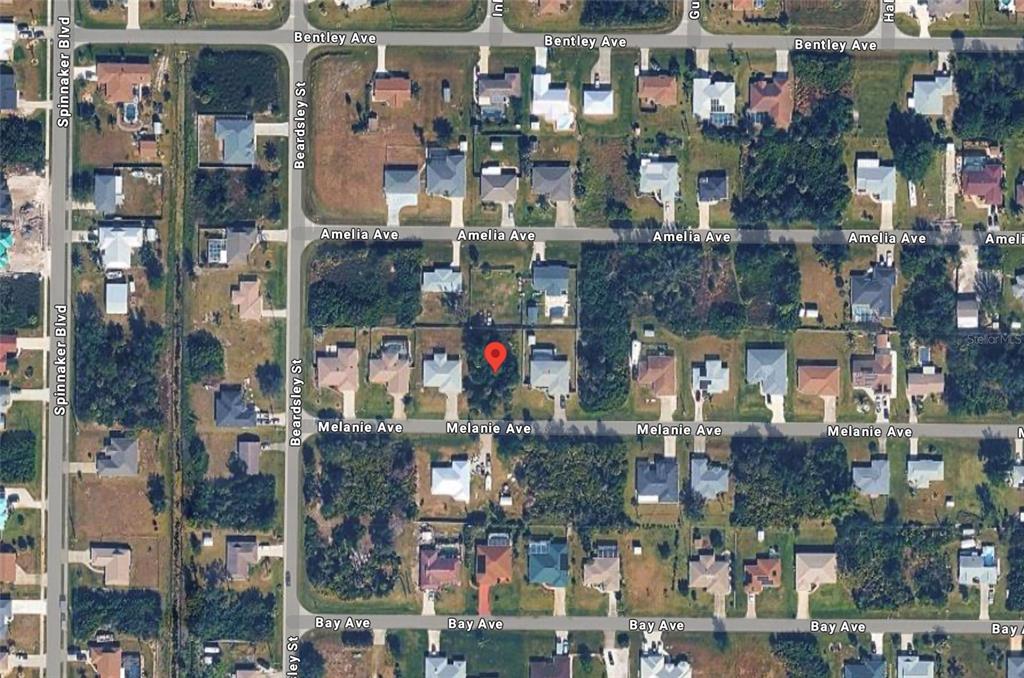 This aerial map shows a residential neighborhood with a red pin marking a vacant lot — 10068 MELANIE AVENUE, ENGLEWOOD, FL