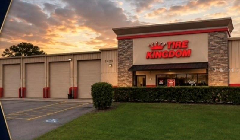 The exterior of a Tire Kingdom commercial building features four garage bays and stone accents — 1429 10TH STREET E, PALMETTO, FL