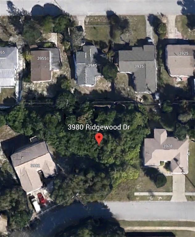 This aerial map shows a wooded residential lot situated between several houses — 3980 RIDGEWOOD DRIVE, TITUSVILLE, FL