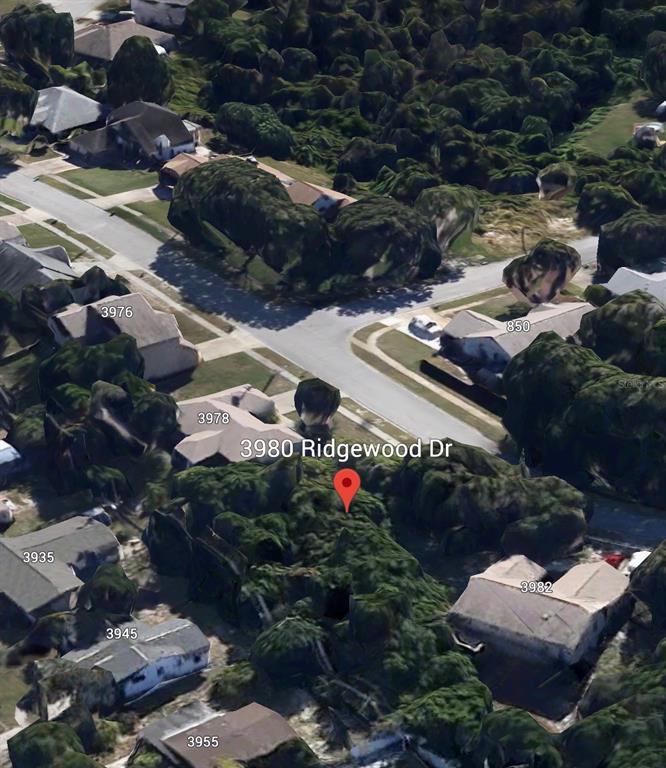 An aerial view of a suburban neighborhood showing residential houses and streets — 3980 RIDGEWOOD DRIVE, TITUSVILLE, FL