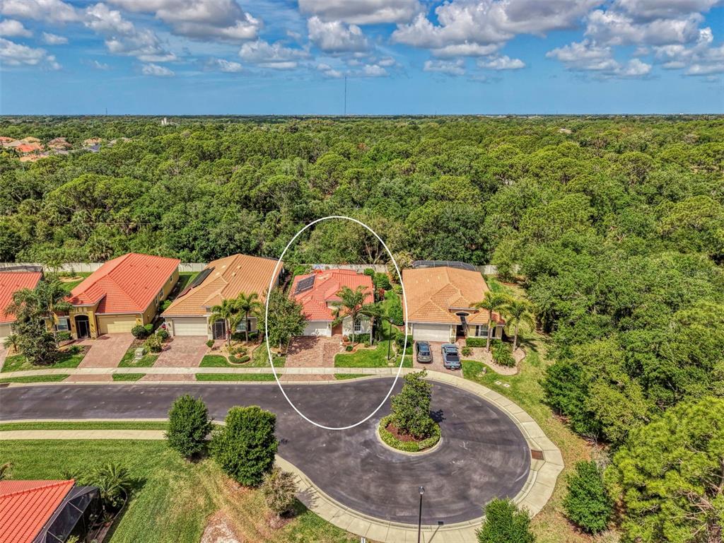 An aerial view shows a house with a red tile roof in a cul-de-sac — 11455 BLACKFIN STREET, VENICE, FL